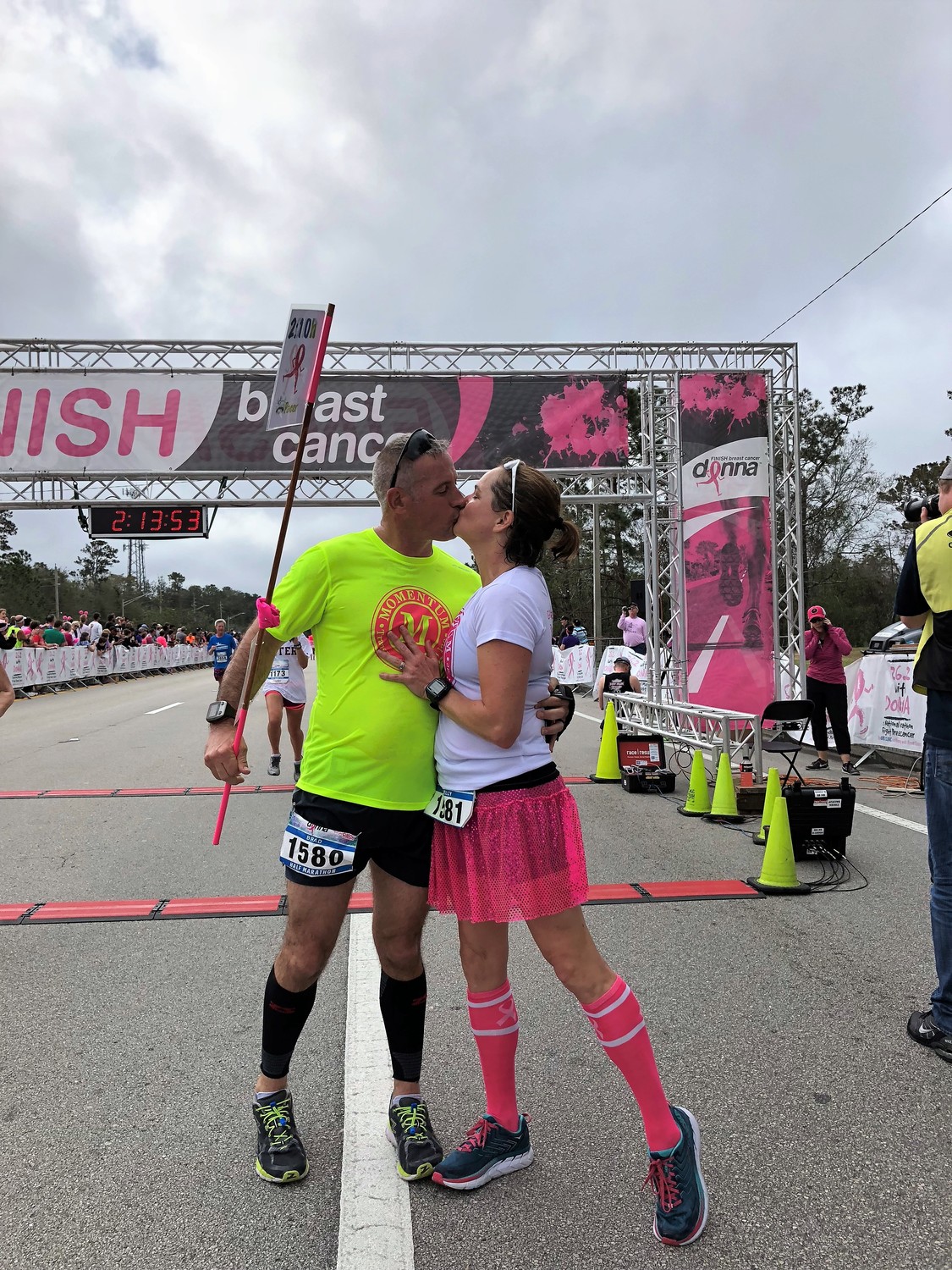 A couple shares a congratulatory kiss after crossing the finish line.