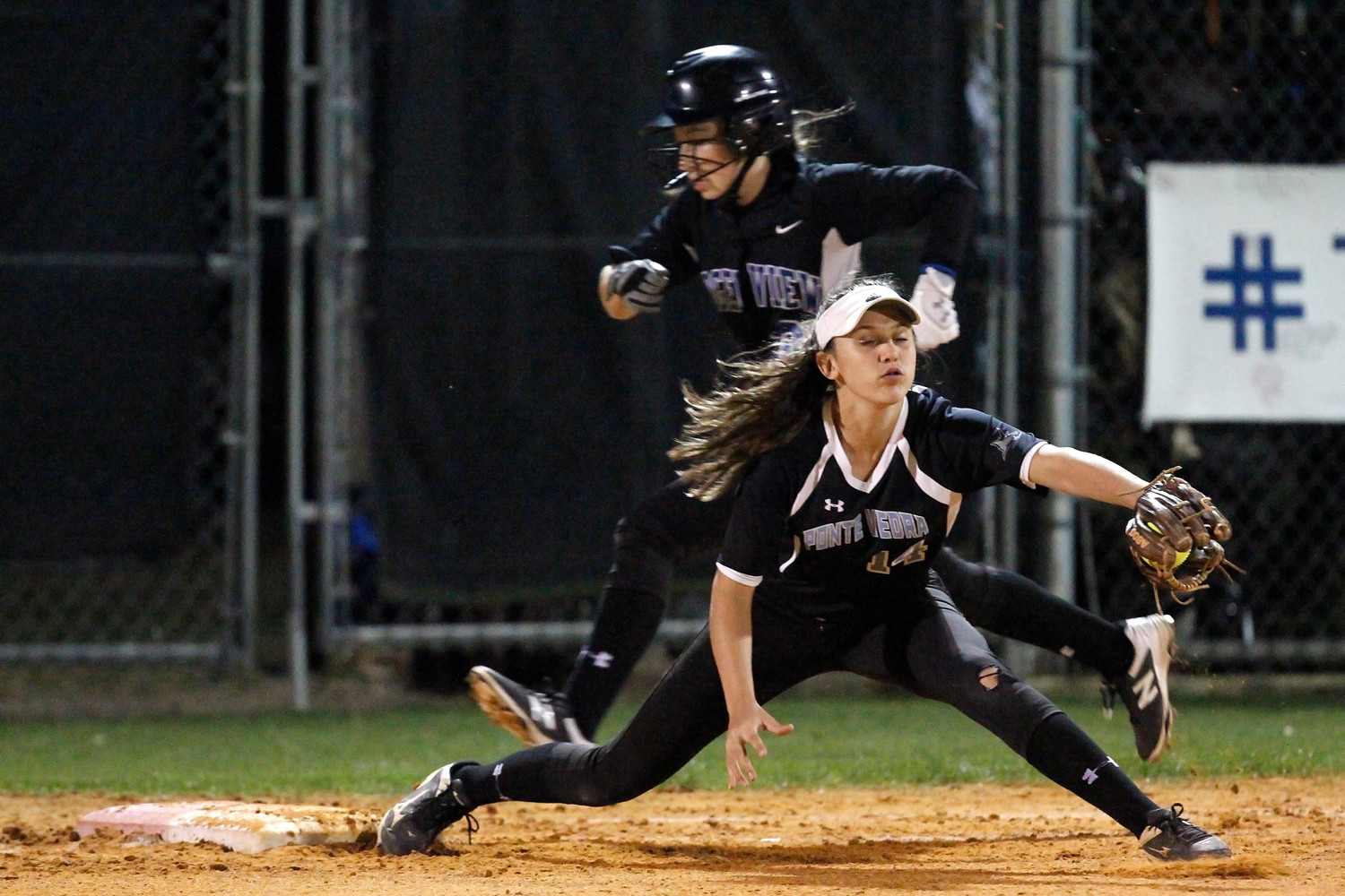 Ponte Vedra’s Catherine Beaton (14) stretches to get the Ridgeview runner out at first base.