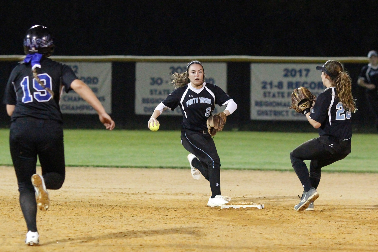 Sharks shortstop Michelle Leone retires the lead runner, but the throw to first was not in time to turn the double play.