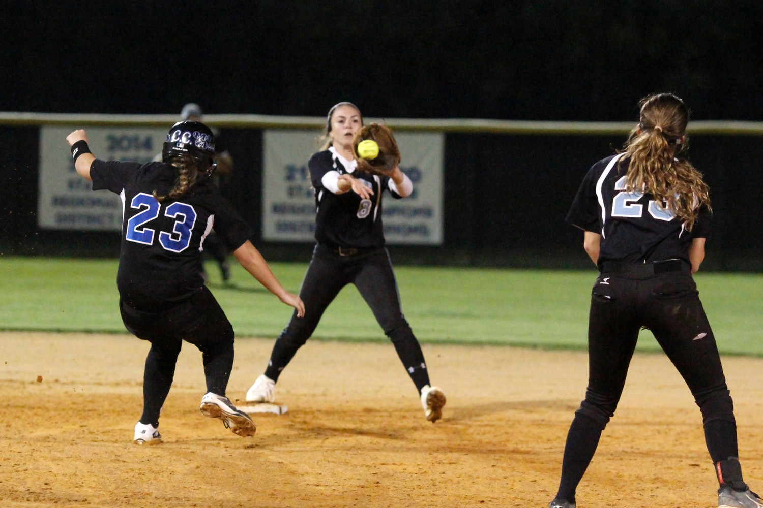 Shark Shortstop Michelle Leone take the throw from second baseman Kiley 
Hennessey for a force-out at second base.