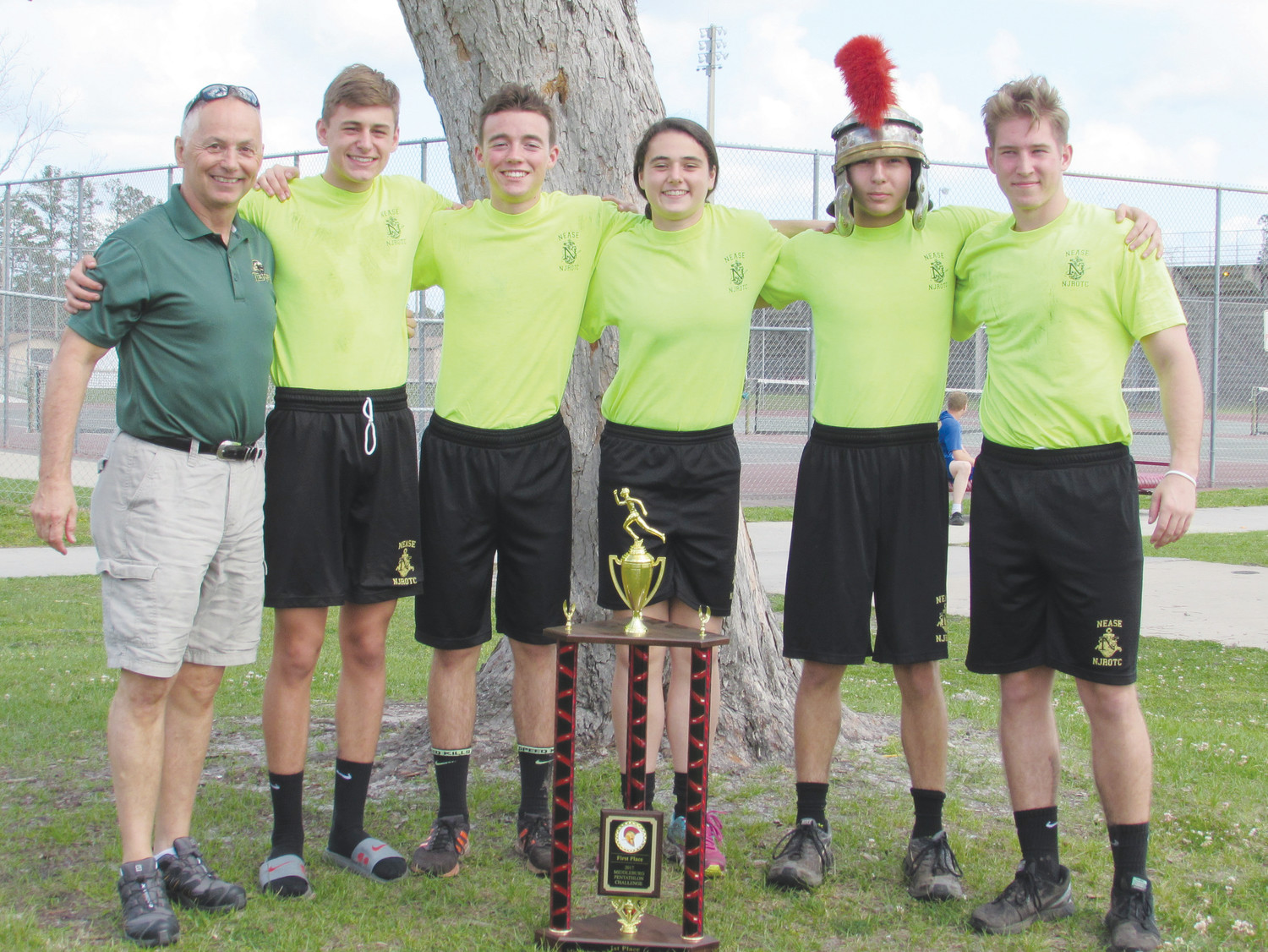 Senior Naval Science Instructor Captain Scott LaRochelle (from left), Peyton Gustafson, Troy Barber, Erin Sass, Christopher Oliver and Steven Sarama stand with Nease NJROTC’s first-place trophy.