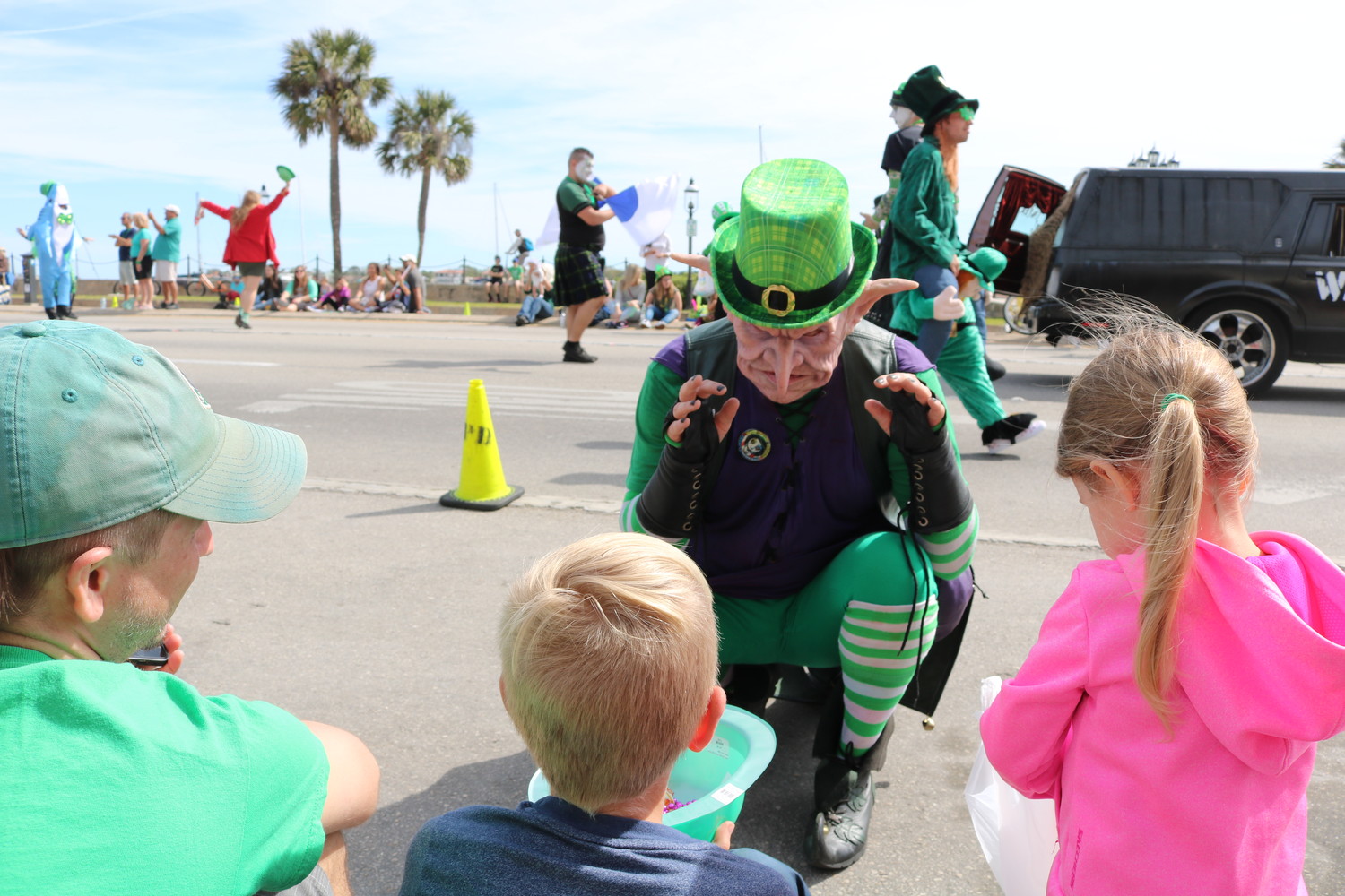 A creepy character pays a visit to a group of kids at the parade.