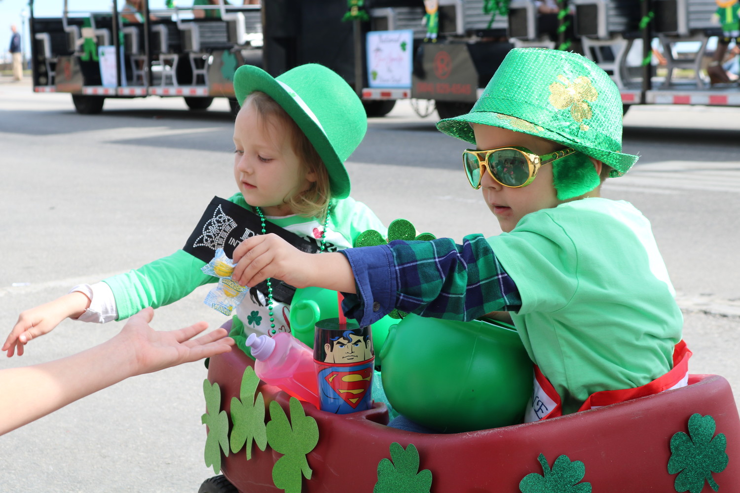 A pair of kids hands out candy during the parade.