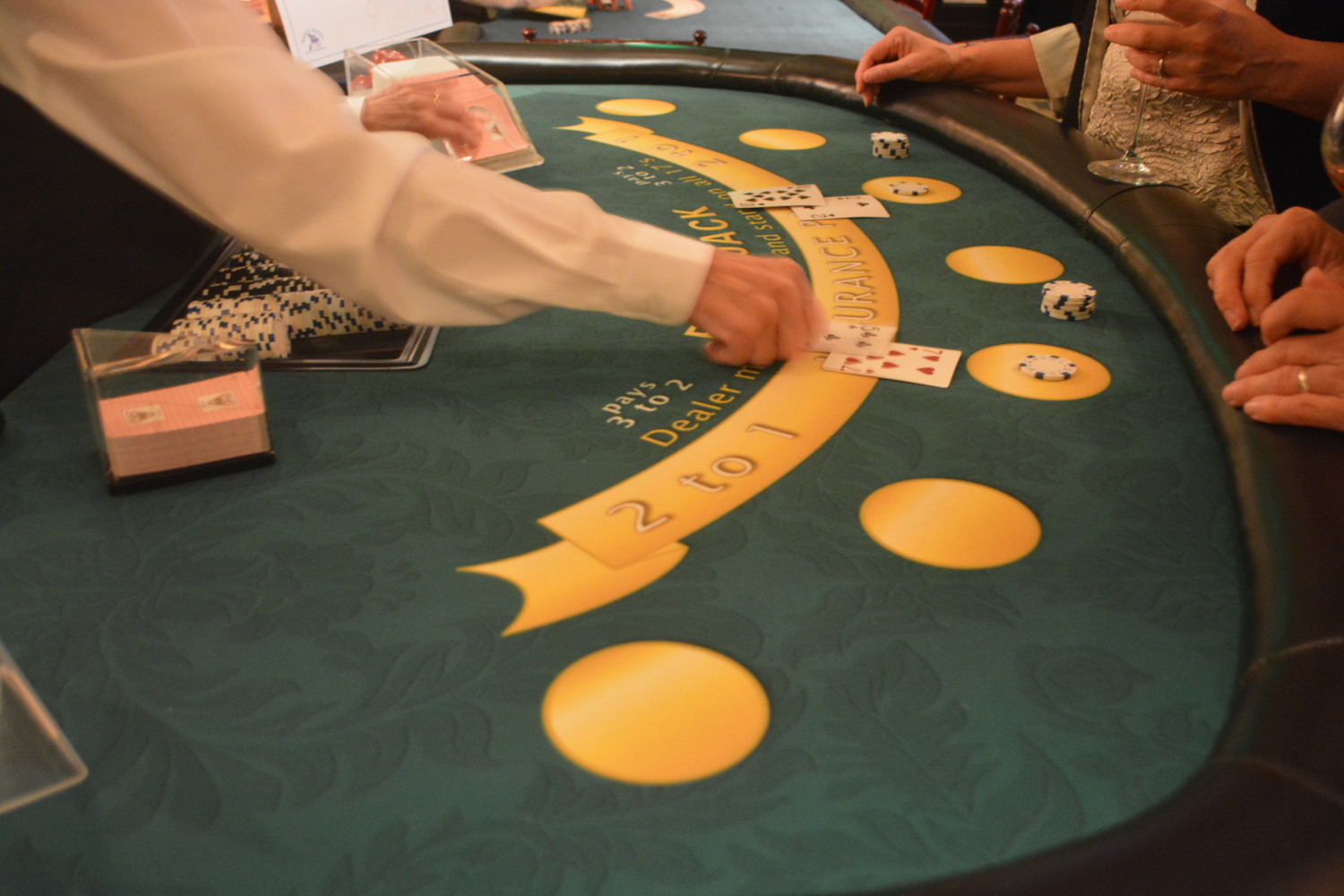 Attendees play cards at Casino Night on the Greens.