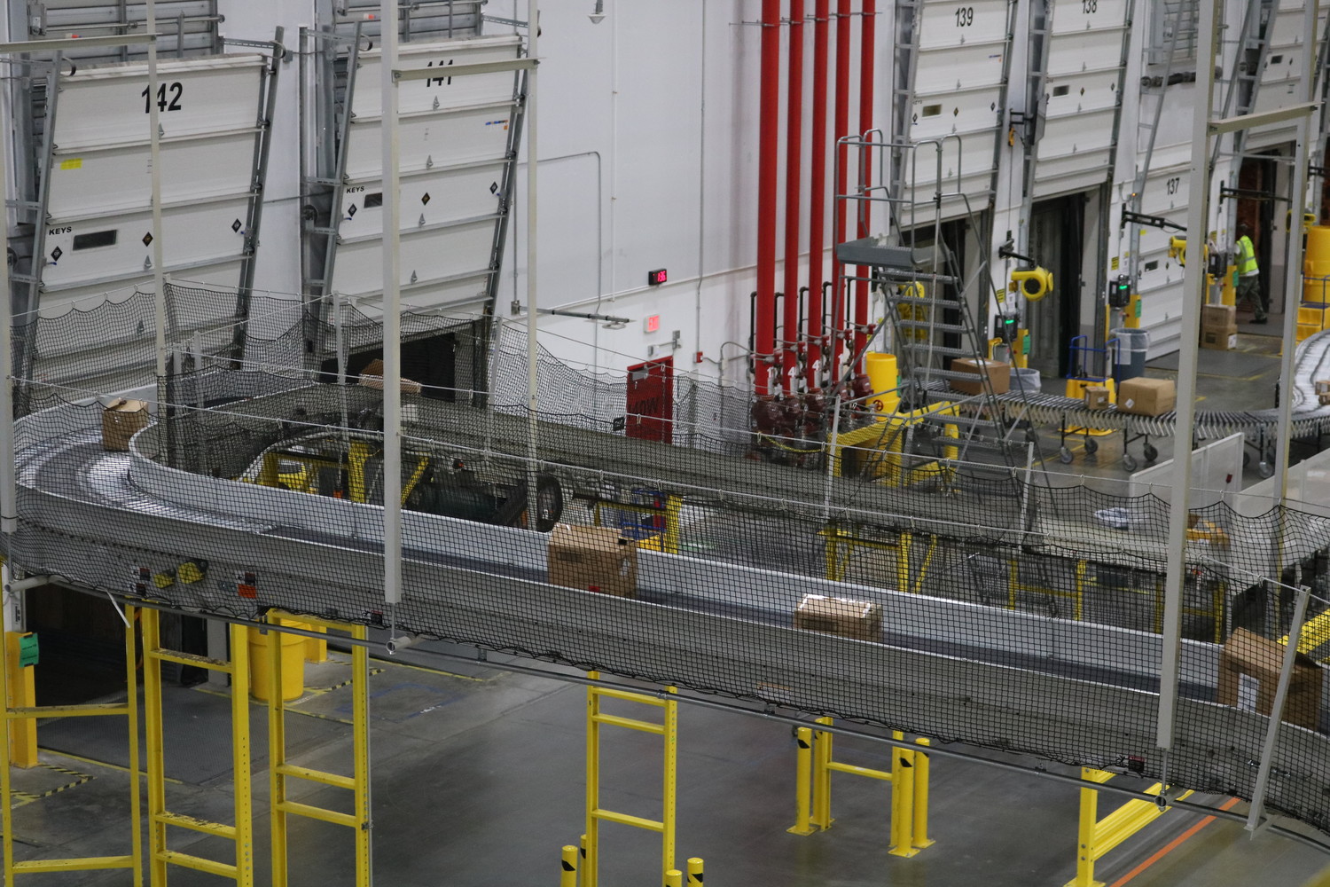 Conveyor belts move packages to a shipping area at the new Amazon facility.