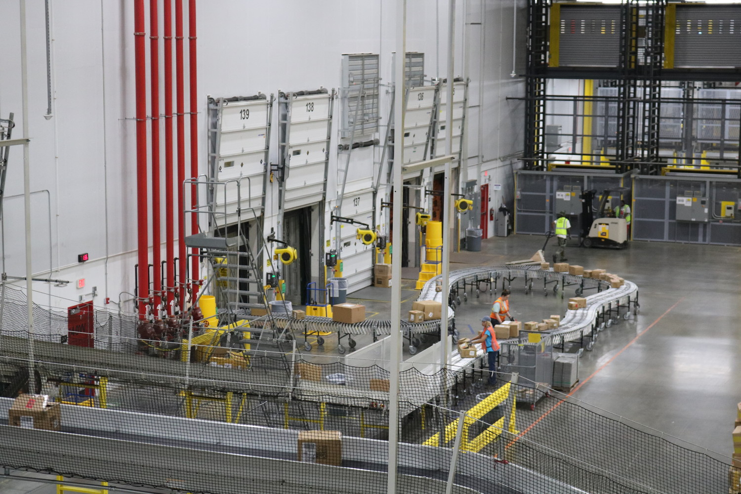 Conveyor belts move packages to a shipping area at the new Amazon facility.