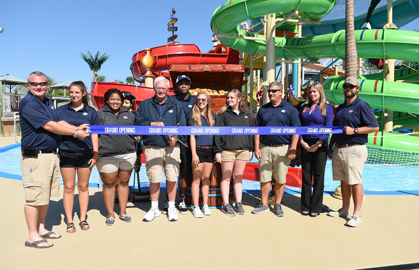 Adventure Landing employees celebrate the opening of Shipwreck Island Waterpark’s new $1 million interactive slide complex with a ribbon cutting ceremony last week.