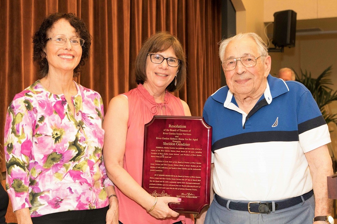 River Garden Senior Services Board President Gloria Einstein and Hebrew Home Board President Susan Cohen present the Lifetime Honorary Trustee award to Sheldon Gendzier, who recently announced his “retirement.”