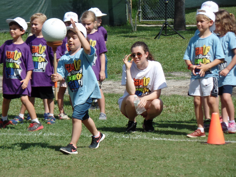 Students run with a ball on a rubber plunger at the 2018 Field Day Event at Bolles Lower School Ponte Vedra Beach Campus.