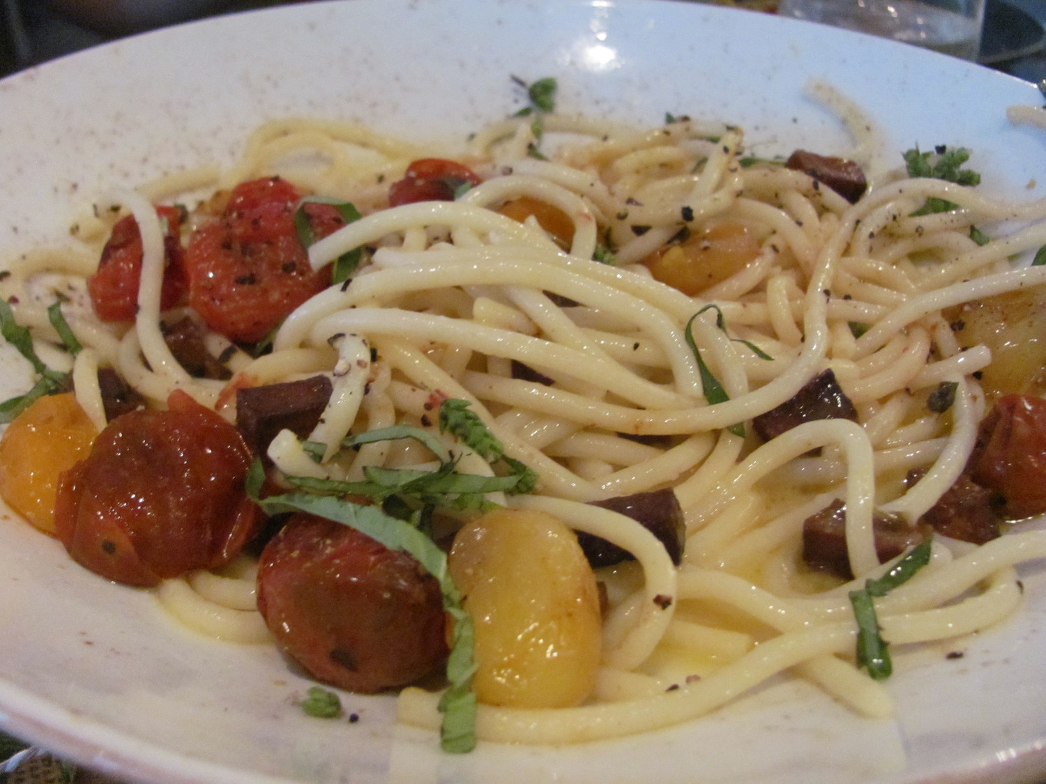 Carbonara with bucatini, vegan egg sauce, herbs, “bacon” and blistered tomatoes