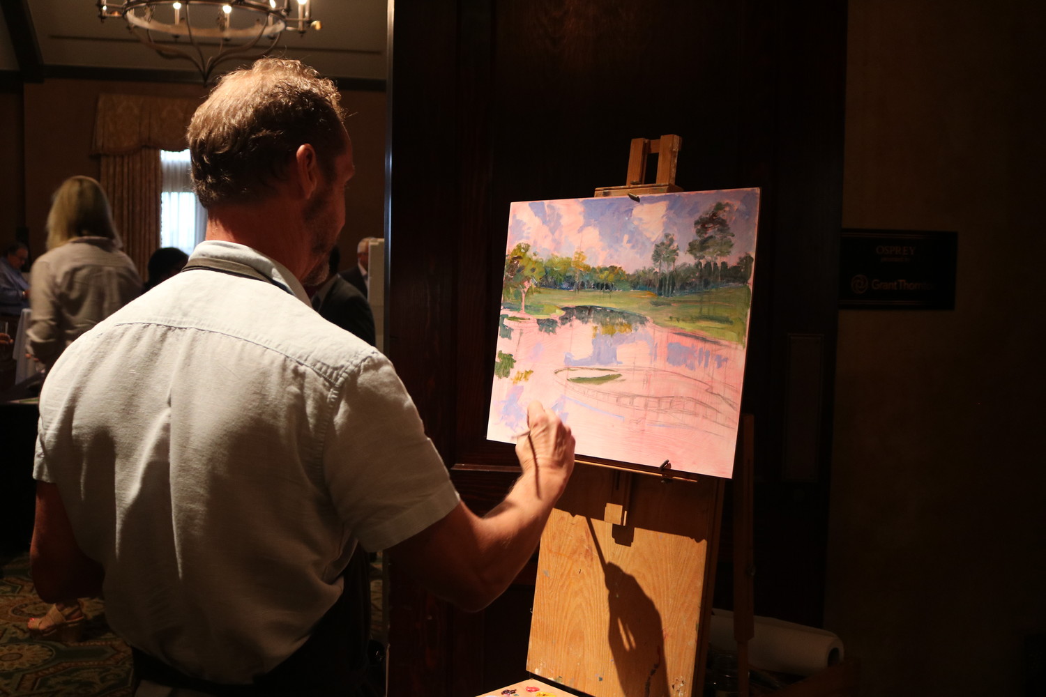 A painter creates a work of art at the Champions for Hope gala at TPC Sawgrass.