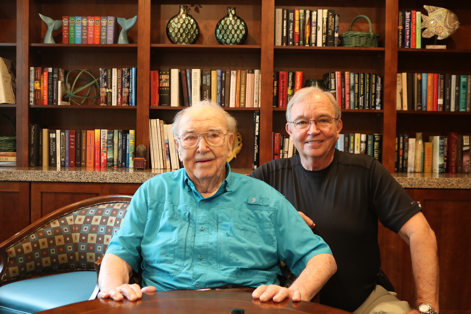 Bud Baisden (left), who is turning 100 July 20, sits next to his son Bill at the library at The Palms at Ponte Vedra.