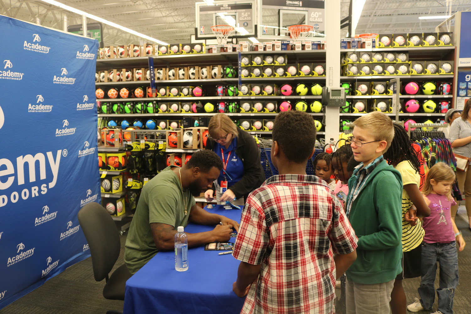 Jaguars linebacker Lerentee McCray signs autographs July 23 at a back-to-school event at Academy Sports + Outdoors for children from the Sulzbacker Village, a community for homeless women and children.