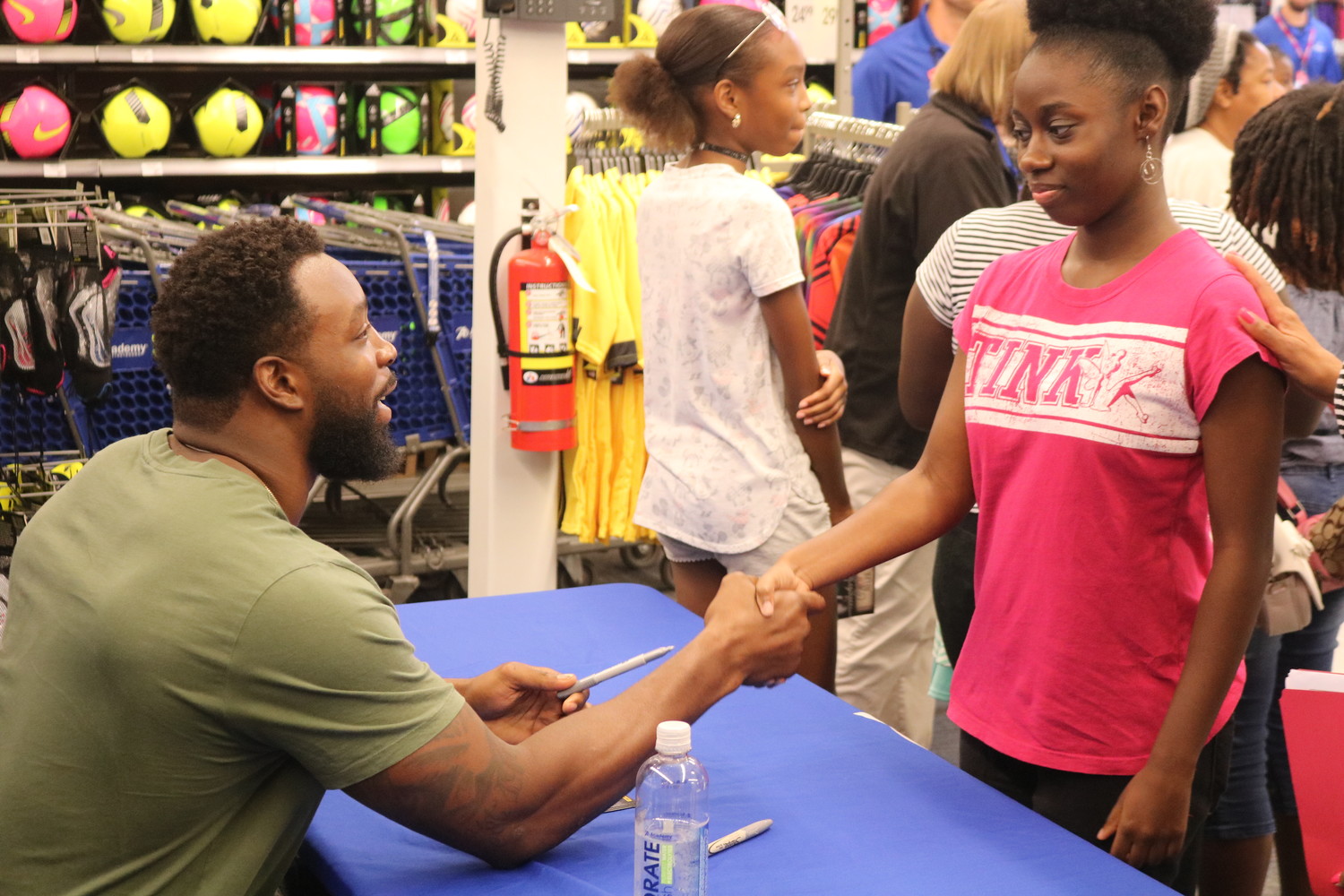 Jaguars linebacker Lerentee McCray signs autographs July 23 at a back-to-school event at Academy Sports + Outdoors for children from the Sulzbacker Village, a community for homeless women and children.