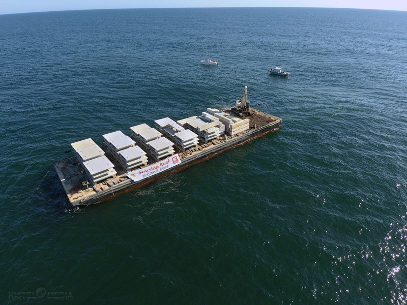 A ship deploys the concrete structures necessary to construct the Coastal Conservation Association / Building Conservation Trust Starship Reef Project.