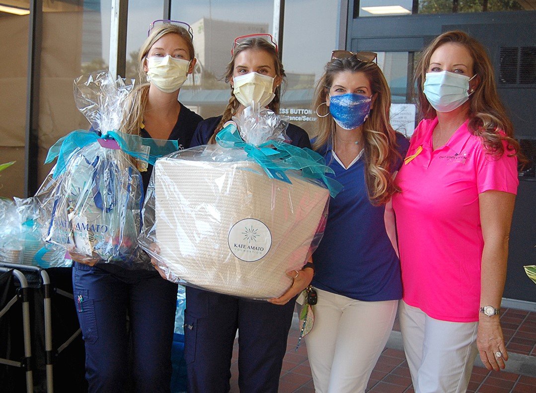 Wolfson Child Life specialists, left, receive Kate’s Kindness Project baskets from Lisa Amato (Kate Amato Foundation) and Tina Toomey (Once Upon a Room).