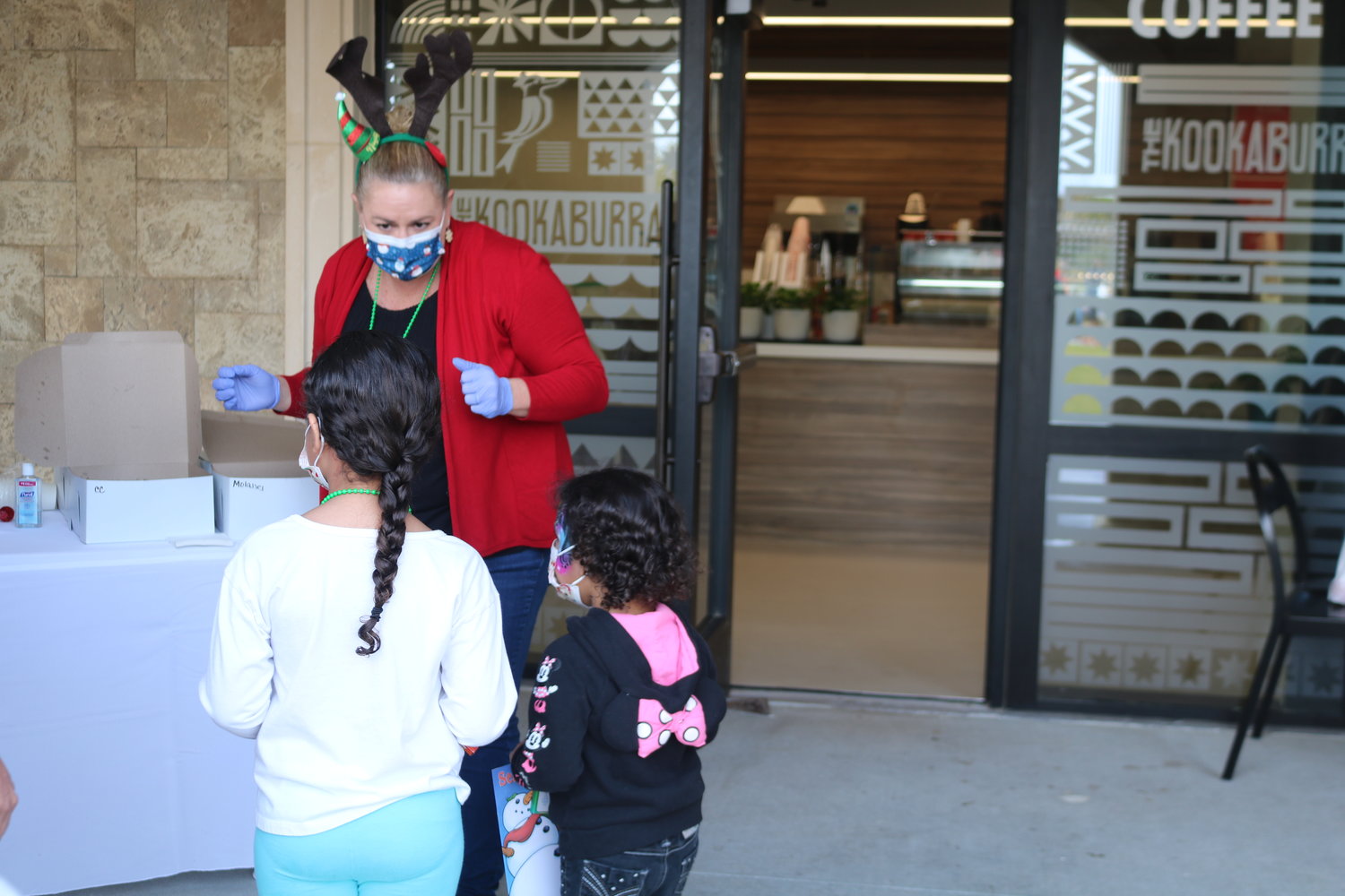 Children wait in line for a cup of hot chocolate from Kookaburra Coffee.