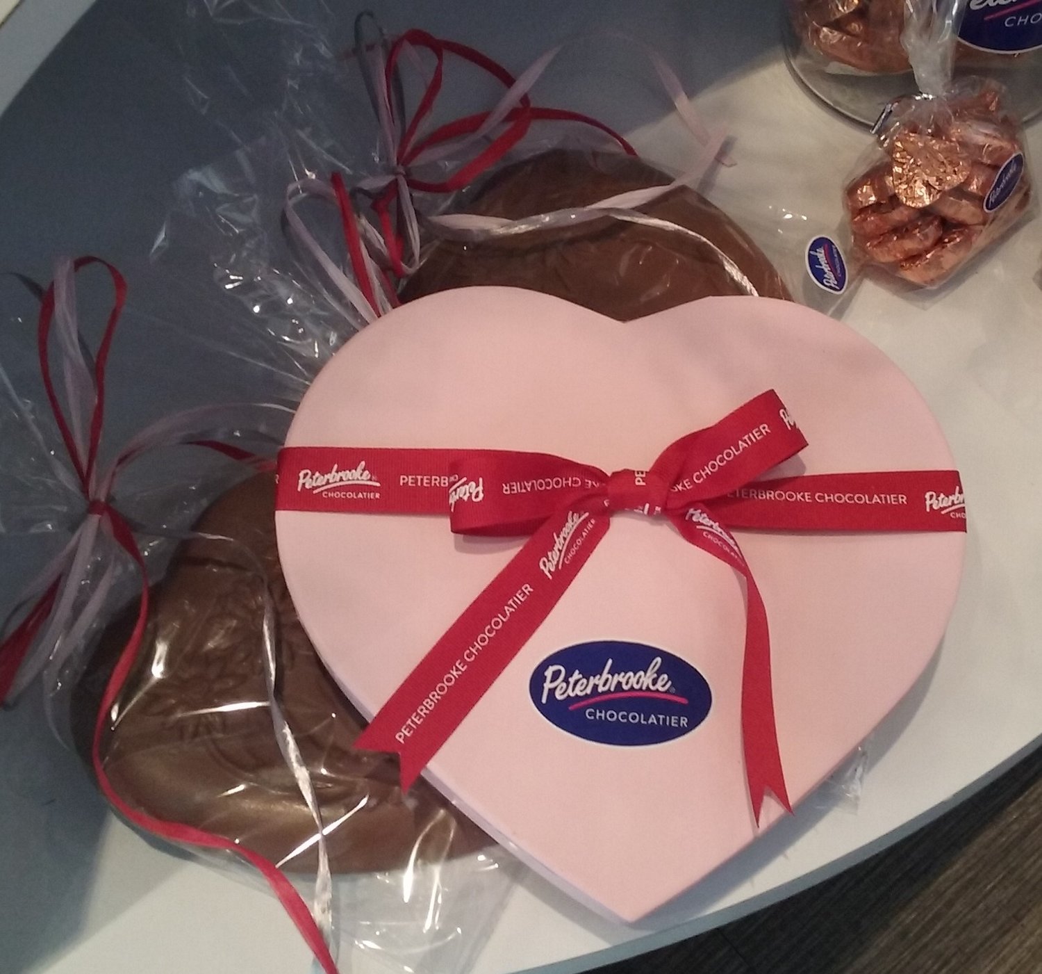 Heart-shaped boxes contain a variety of chocolate samples. This one has 22 pieces.
