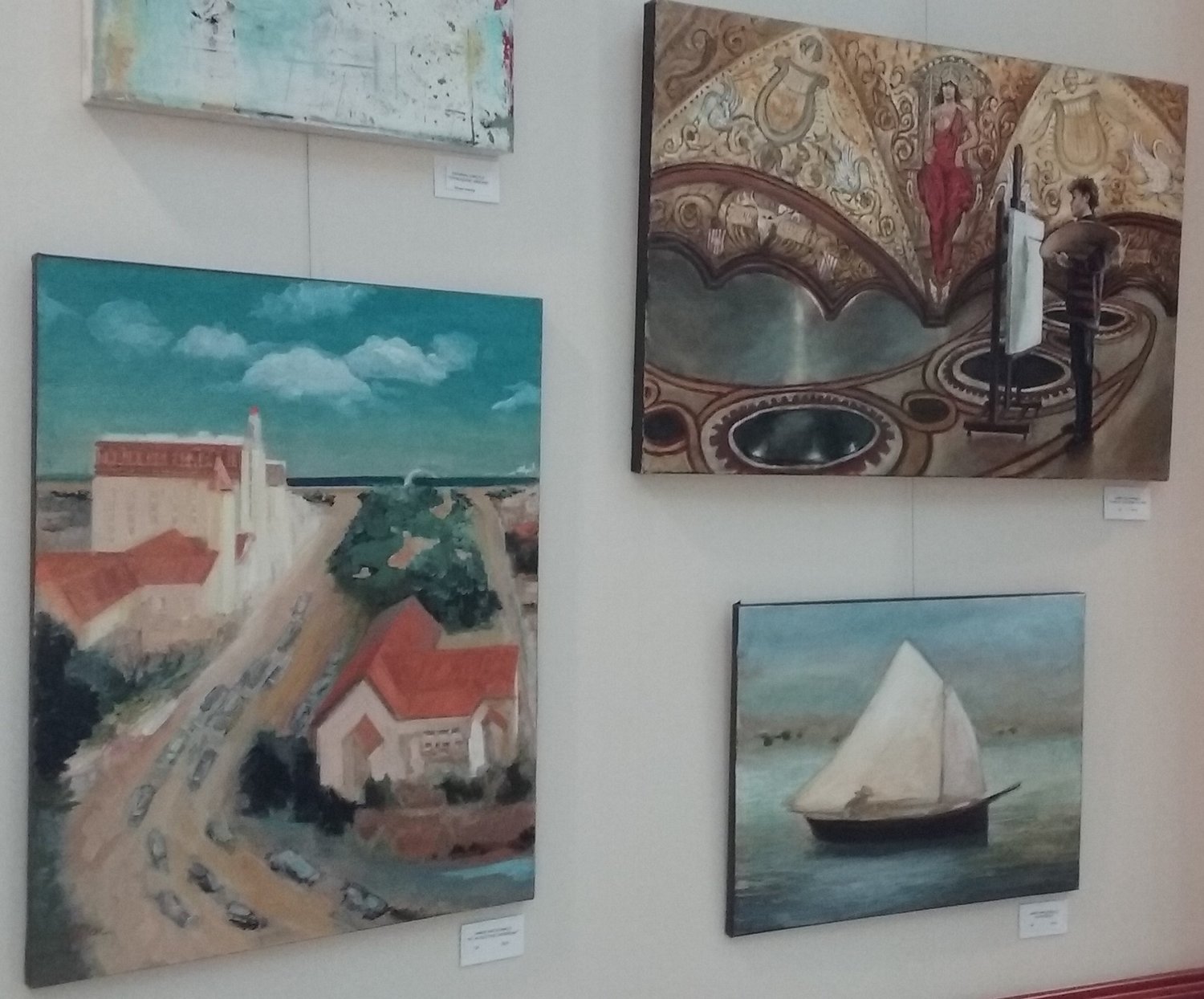 Several works of art are seen on one wall.