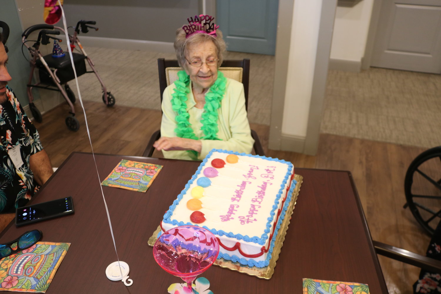 Dorothy Coy looks at the birthday cake she shared with another resident of Starling at Nocatee Assisted Living & Memory Care on June 25.