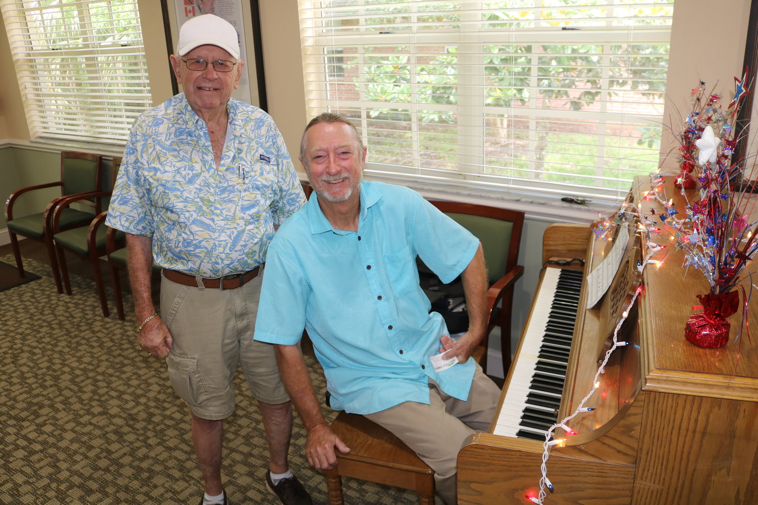 Donnell Miniard, right, performed musical selections on a piano for the grand reopening of THE PLAYERS Community Senior Center. Miles Stonesifer, left, took some time to chat with Miniard between sets.