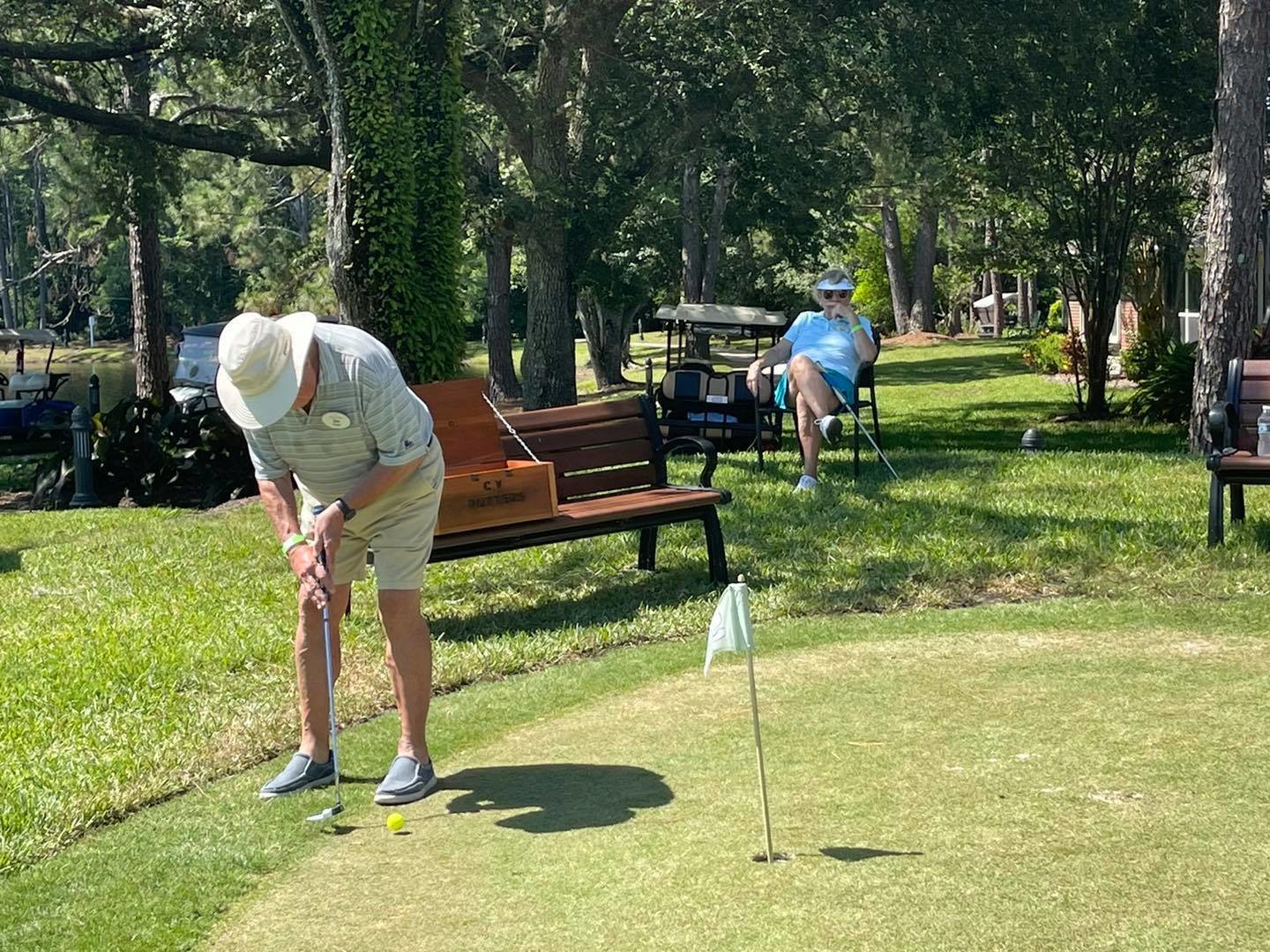 A participant makes a shot during the Putters Tournament at Cypress Village.