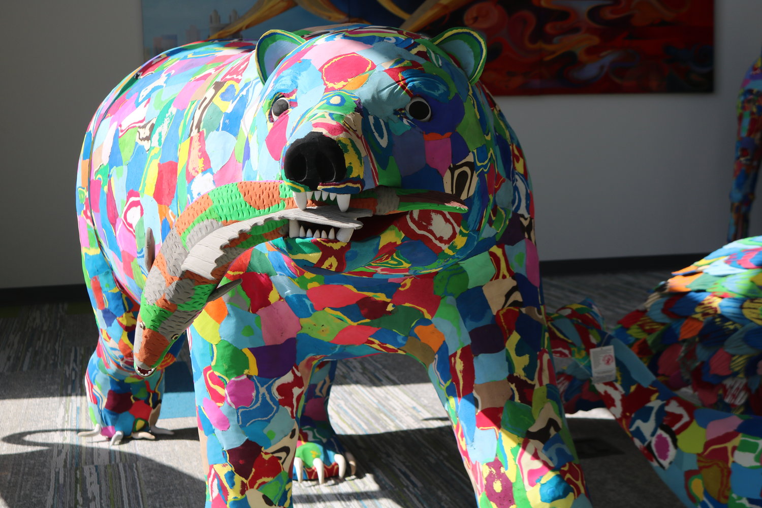 A grizzly made entirely of recycled flipflops — the work of Ocean Sole — stands near the entrance to the link.