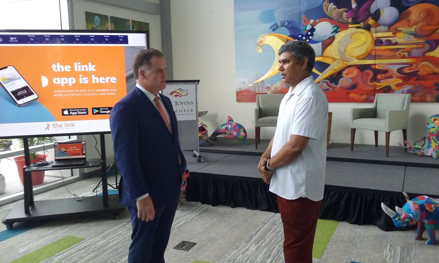 Flagler Health+ President and CEO Jason Barrett chats with entrepreneur Raghu Misra during grand opening festivities for the link on Wednesday, July 14.