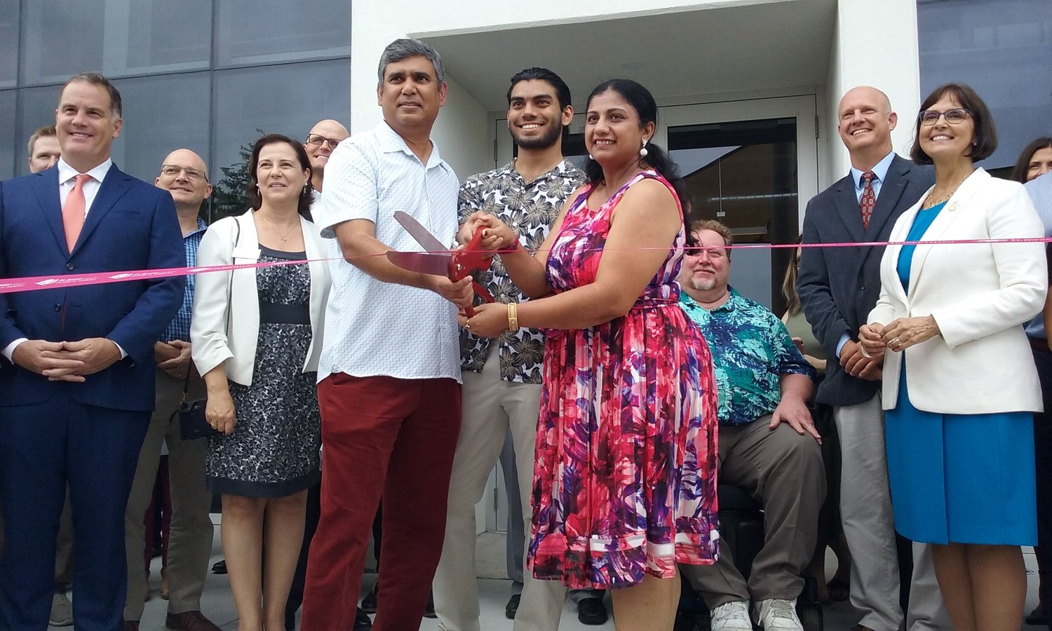Raghu Misra, son Rohan Misra and wife Gurpreet Misra cut the ribbon on the link during grand opening festivities Wednesday, July 14.
