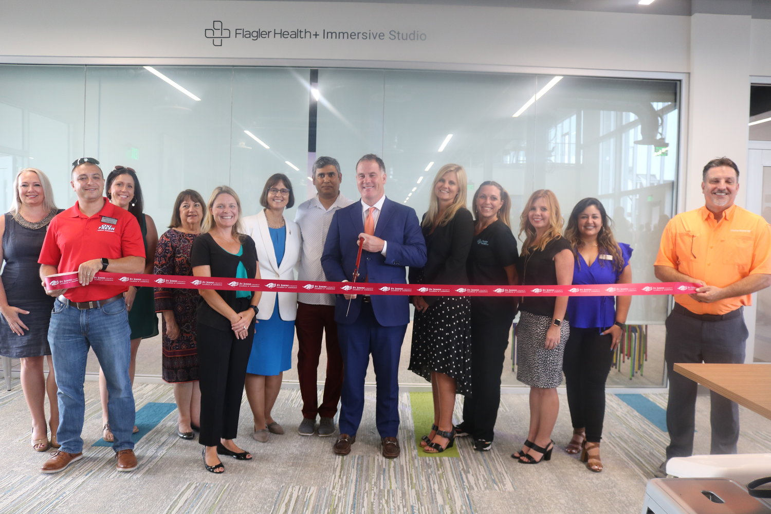 Flagler Health+ President and CEO Jason Barrett cuts the ribbon on the Flagler Health+ Immersive Studio during grand opening festivities for the link on Wednesday, July 14.