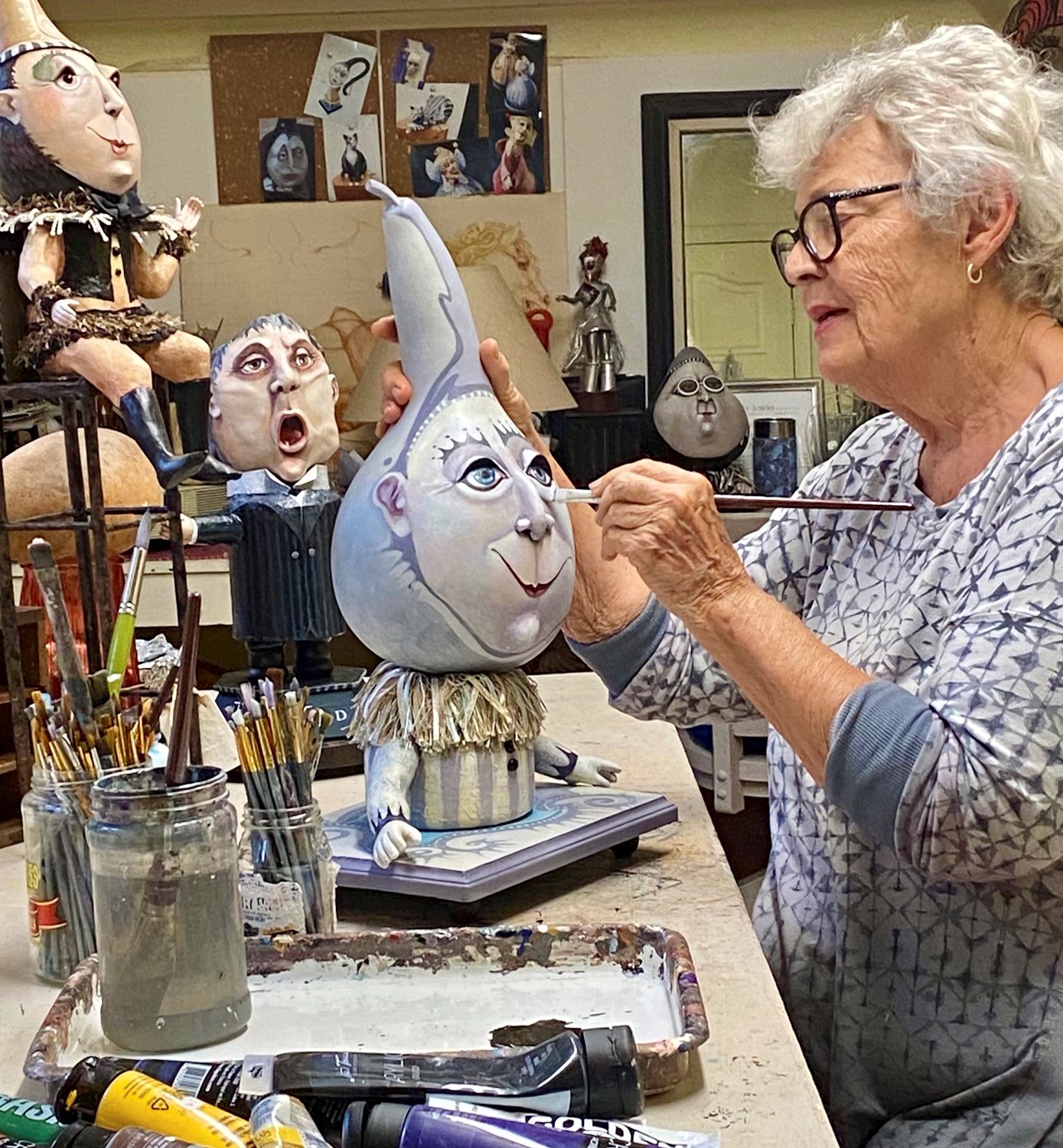 Artist Jan Miller works on one of her whimsical sculptures in her studio.