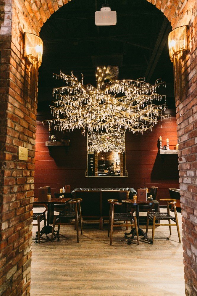 The focal point of Coastal Wine Market's expanded space is a custom-made crystal chandelier.