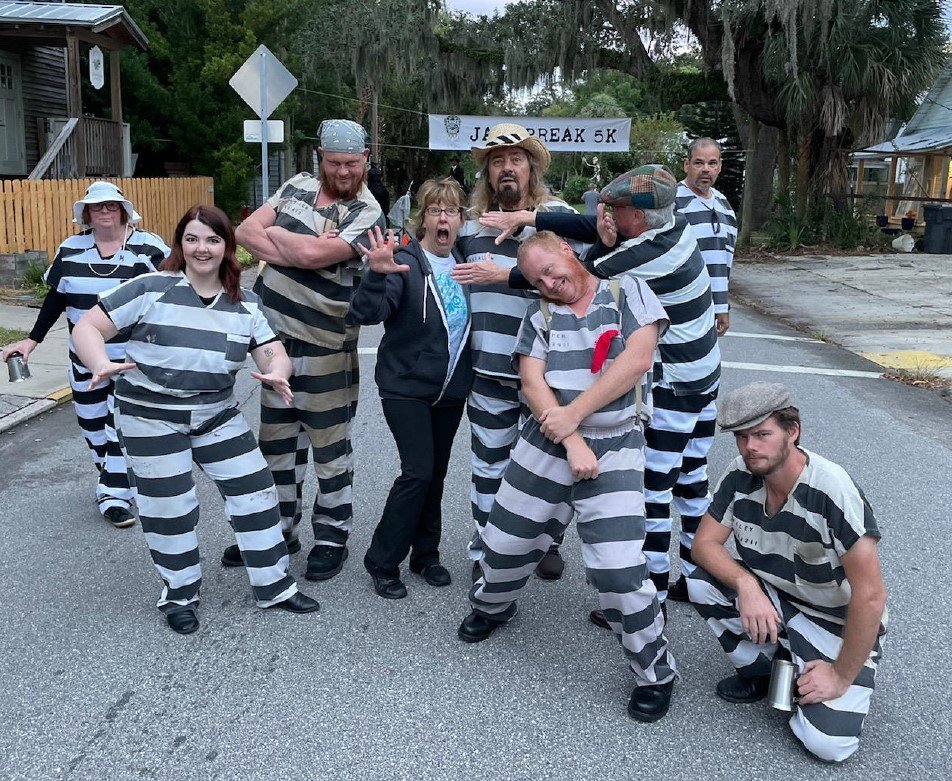 INK! Executive Director Donna Lueders is seen with volunteers and cast members from Old Town Trolley Tours at the Jail Break 5K.