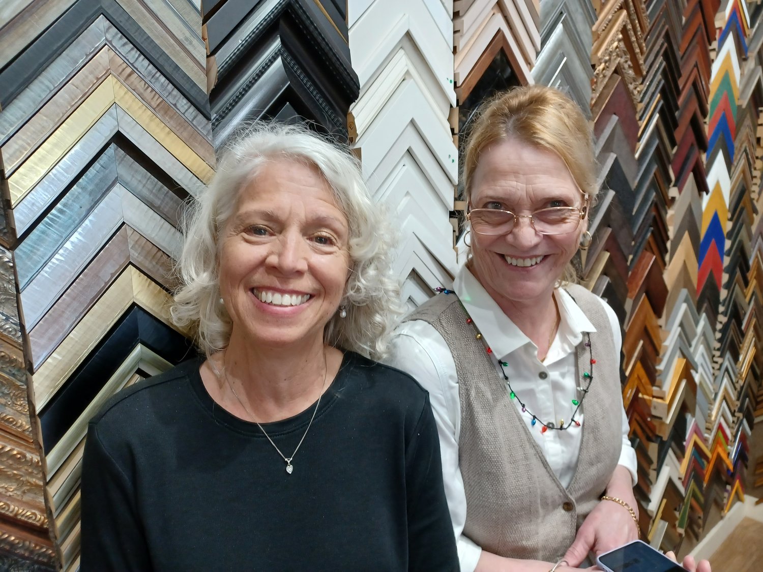 Lisa Cederberg, left, and Pamela Keegan welcomed the public to their business, Village Arts Framing and Gallery, during a holiday open house on Saturday, Dec. 11.