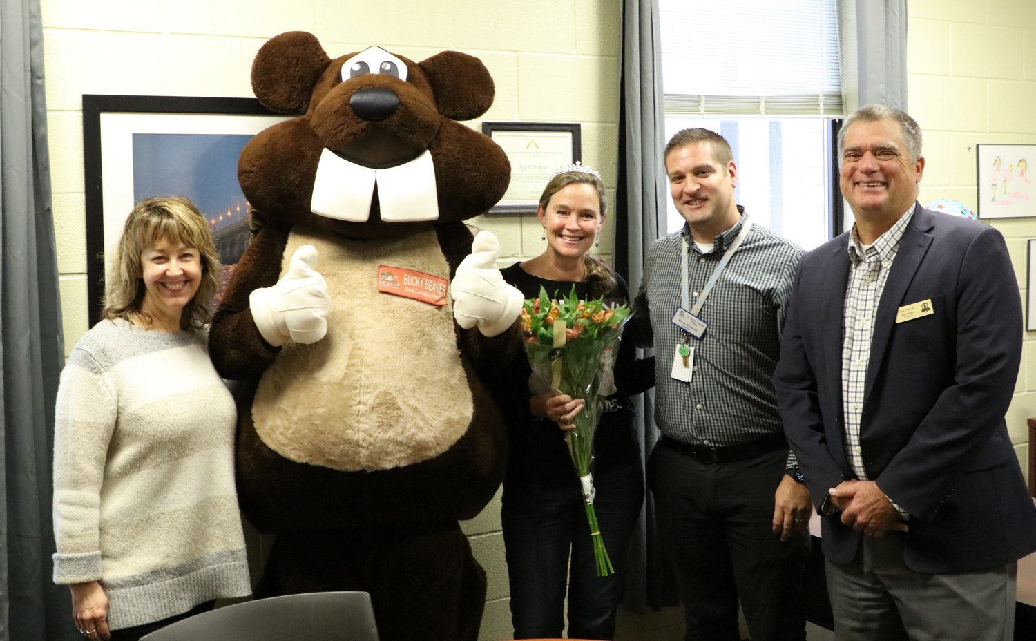 Donna Lueders, INK! executive director; Bucky the Beaver; Patricia McElhone, St. Johns Virtual School (with flowers); Ryan Erskine, school principal; and St. Johns County School District Superintendent Tim Forson.