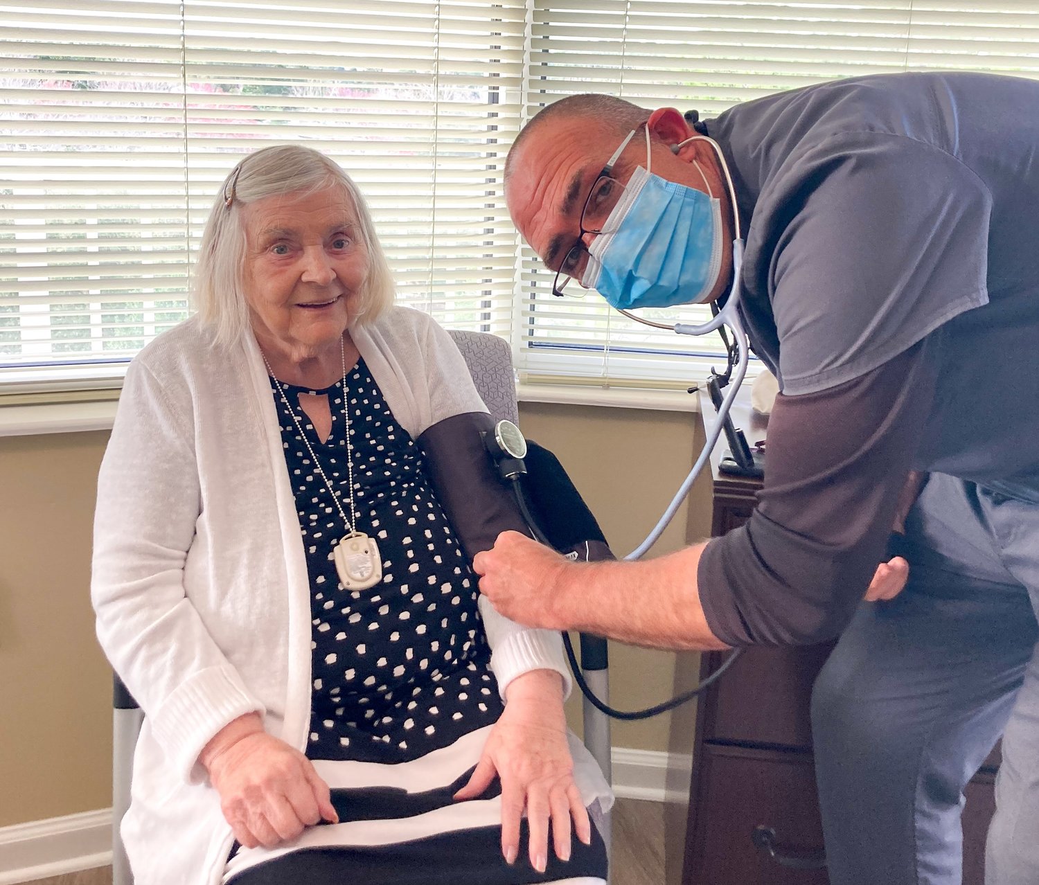 William Grieco, director of health and wellness at Cypress Village, is seen with a resident.