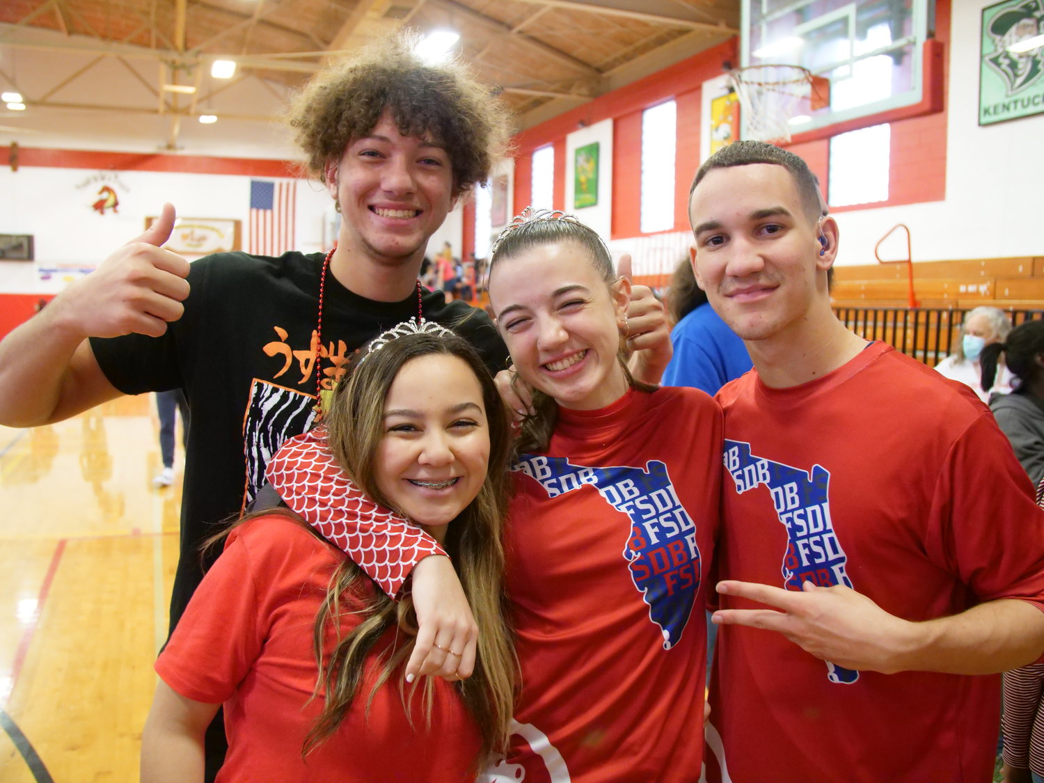 Athletes from the FSDB Deaf Department are all smiles. Senior Cassidy Dainty is in the center.