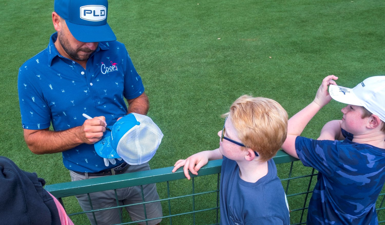 A young fan gets an autograph on Wednesday, March 9, from one of stars of THE PLAYERS Championship.