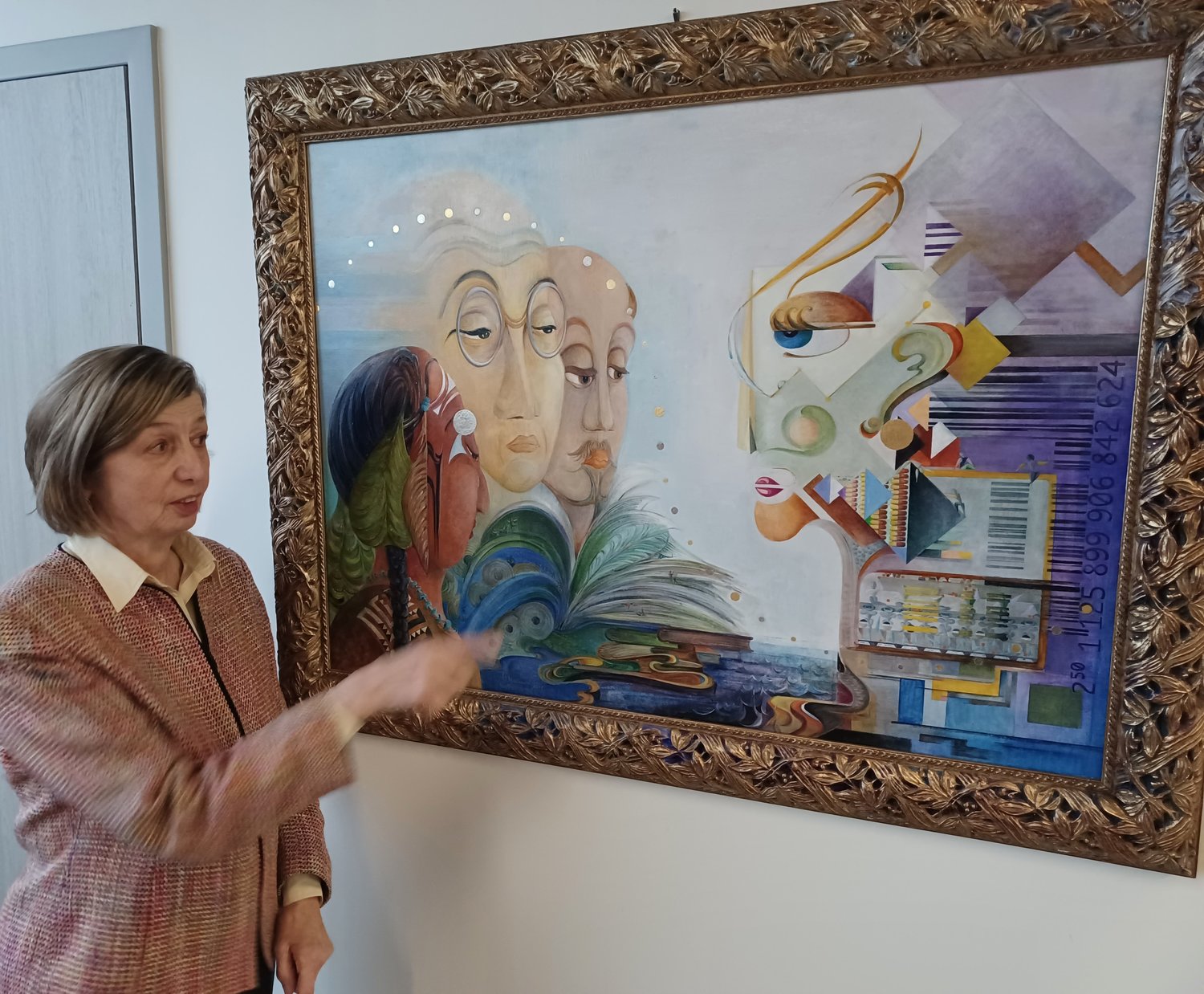 Susanne Schuenke points out some of the elements of her oil-and-gold-leaf painting, “Petabyte Abyss,” during a recent Artist Walk & Talk at the link.
