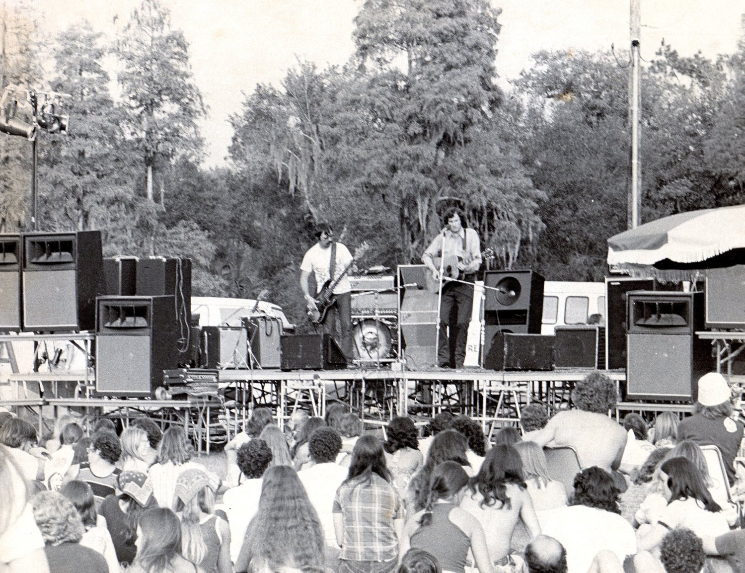 The late Gamble Rogers performs on an outdoor stage.