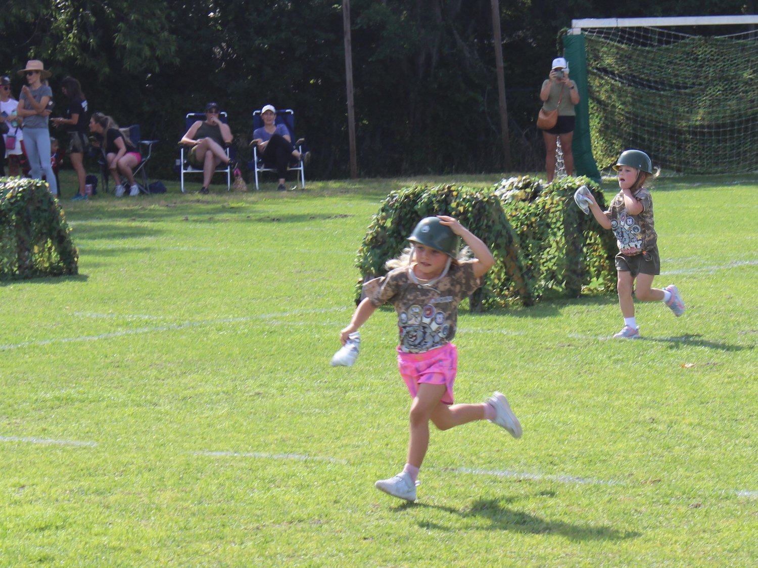 Students from The Bolles Lower School Ponte Vedra Beach Campus run a relay race during their military-themed field day.