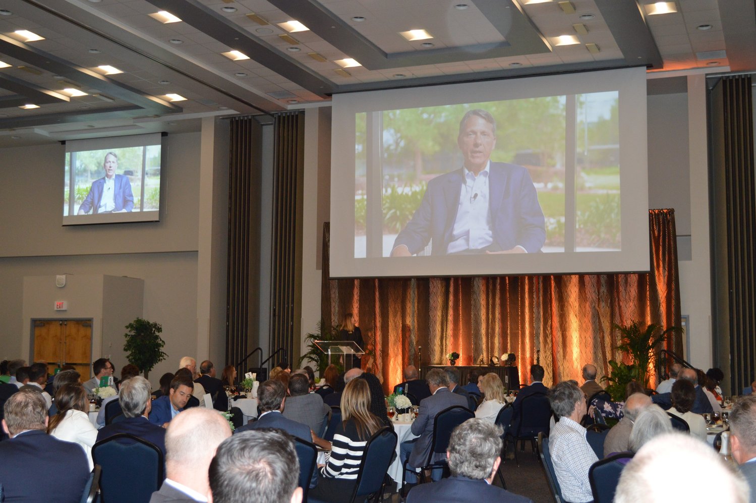 JA of North Florida Hall of Fame inductee Charlie Kauffman speaks via video to those attending the Junior Achievement of North Florida’s 2022 Hall of Fame Luncheon.