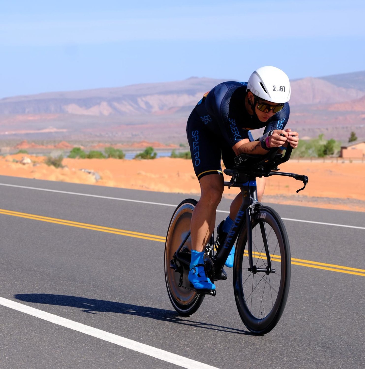 Peyton Thompson cycles along the desert route in St. George, Utah, during the 2021 Ironman World Championship.
