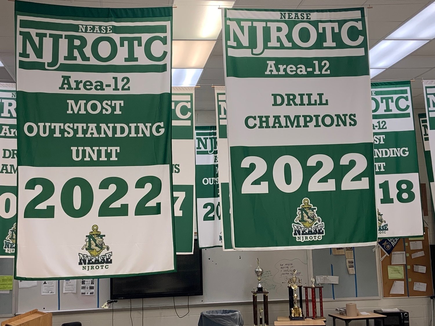 The newly raised 2022 Area-12 Most Outstanding Unit and Area-12 Drill Championship banners hang from the rafters at Nease High School.