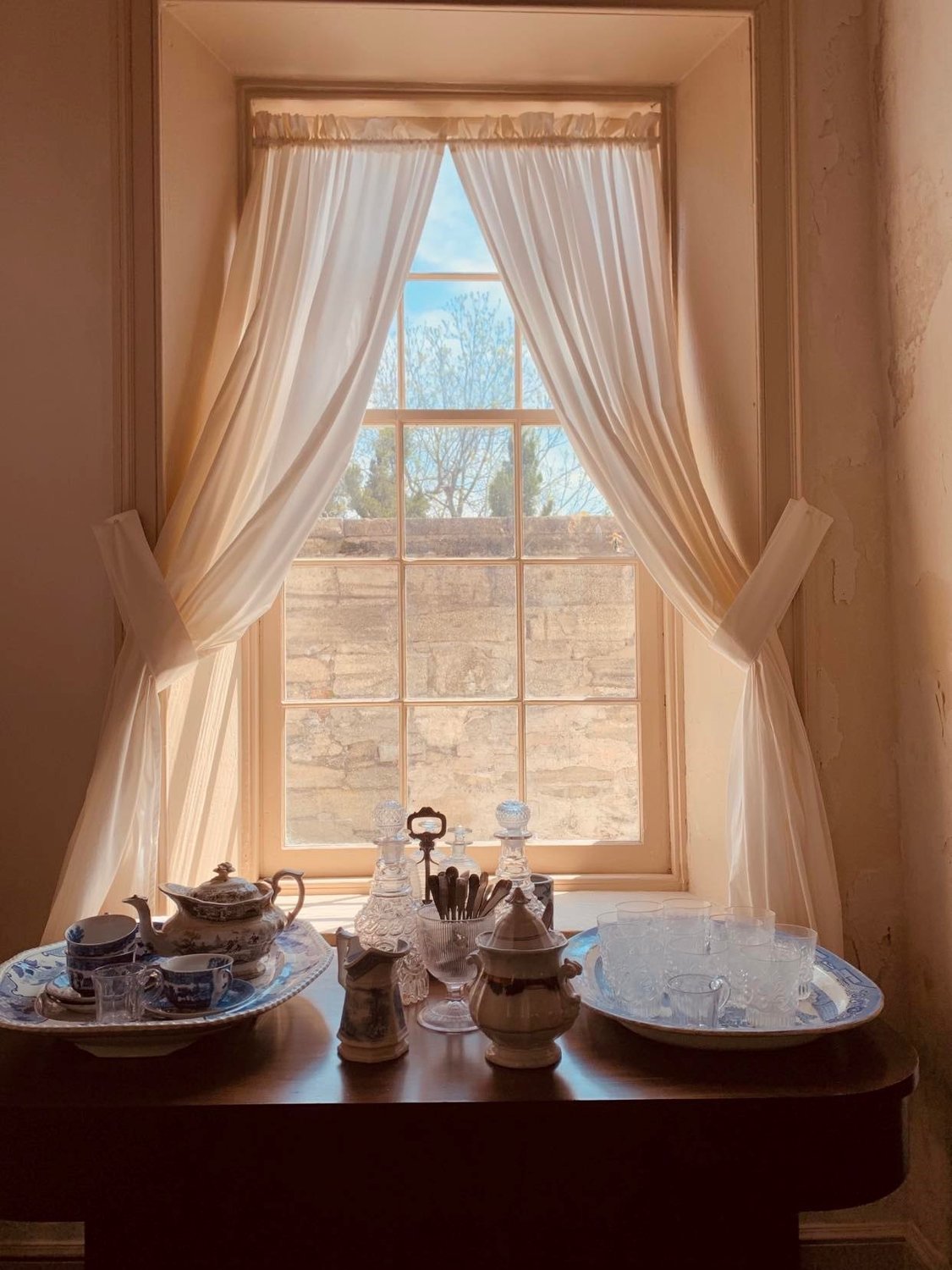 The Americana Corner Grant Program’s $8,000 award will allow The Ximenez-Fatio House Museum to remove mildew from the coquina walls, one of which is seen through this window.