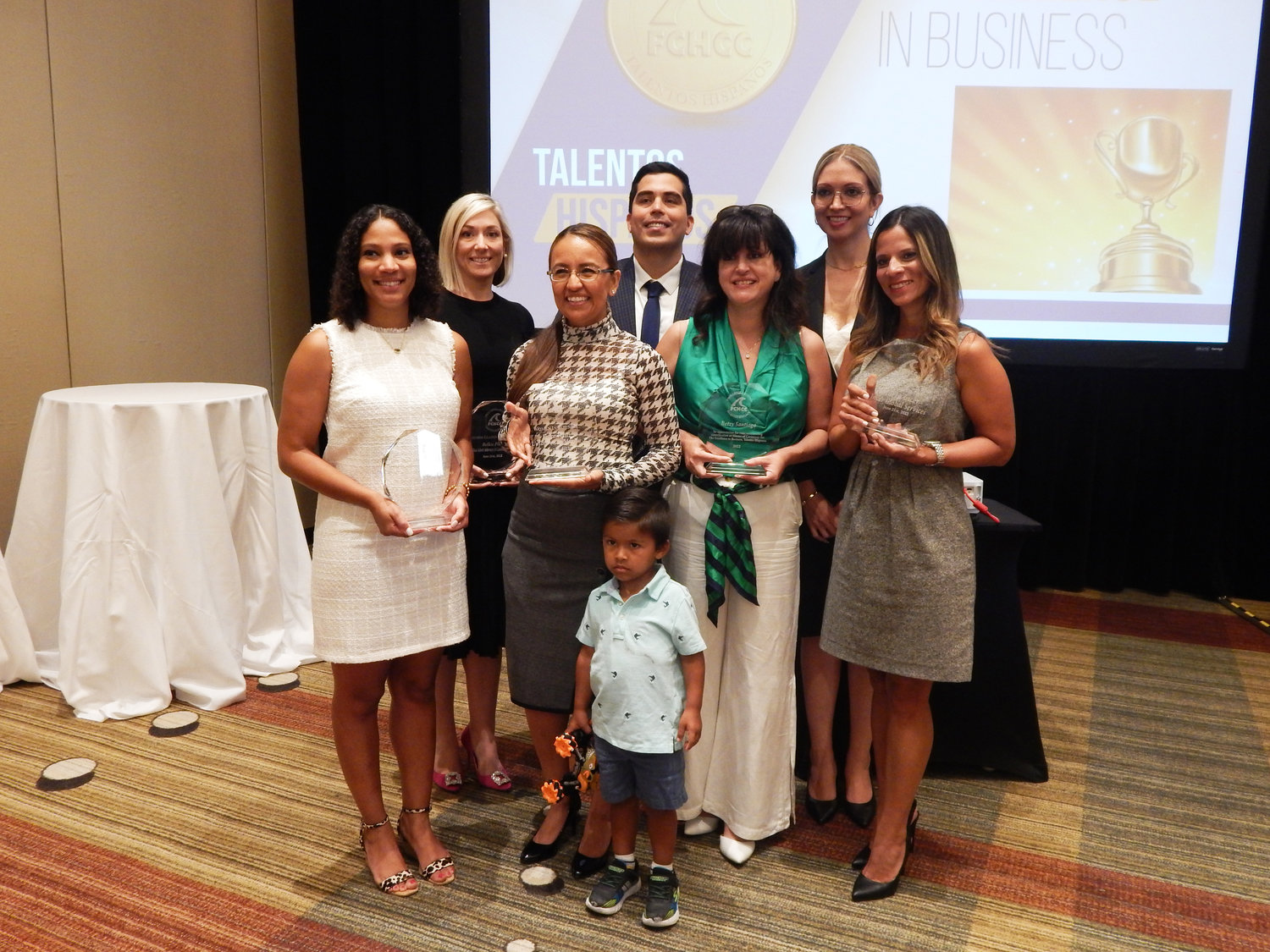 Monica Hernandez, president and CEO of the First Coast Hispanic Chamber of Commerce, stands for a photo with the winners of the organization’s 2022 Excellence in Business Awards.