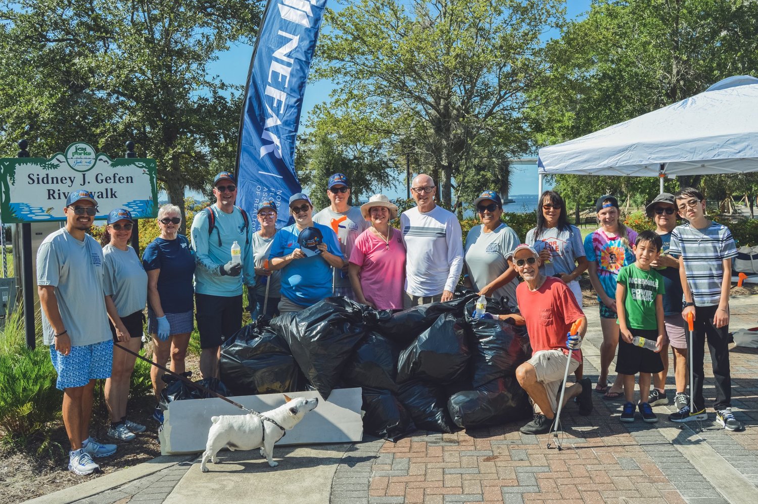 The volunteers at Sidney Gefen Riverwalk Park show off the tremendous amount of trash they collected.