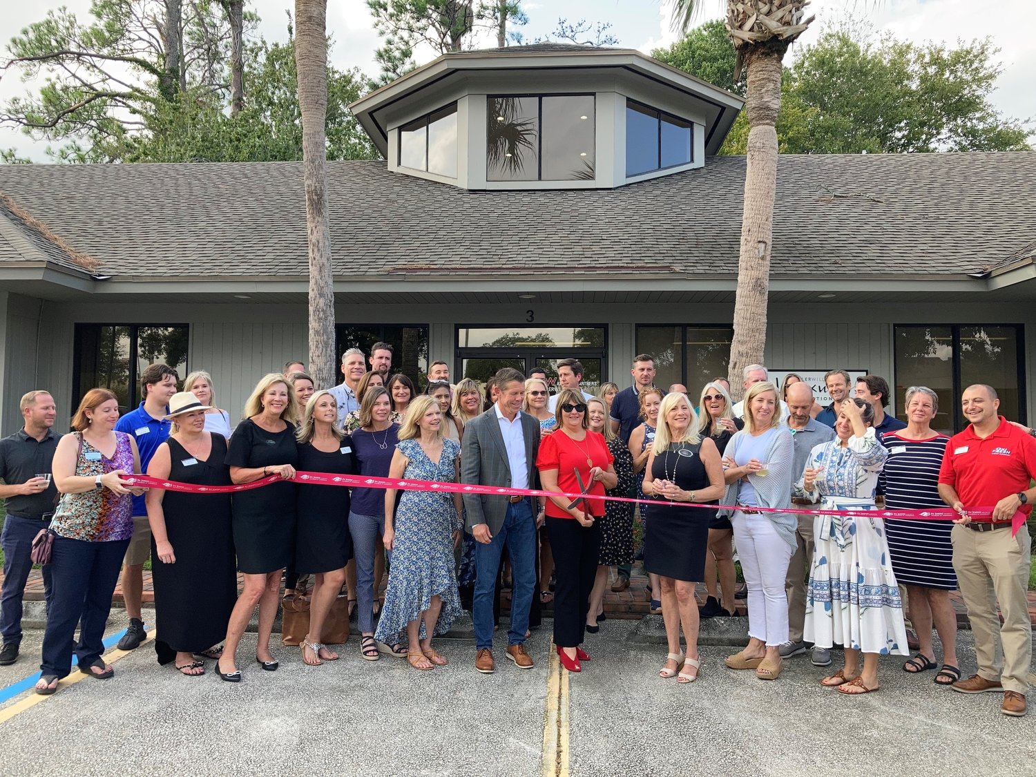 Margaret Sherrill, operating principal, cuts the ribbon for Keller Williams Realty Atlantic Partners’ new office in Sawgrass Village as team leader Mark Dilworth looks on. St. Johns County Chamber of Commerce Ponte Vedra Beach Division conducted the ceremony.