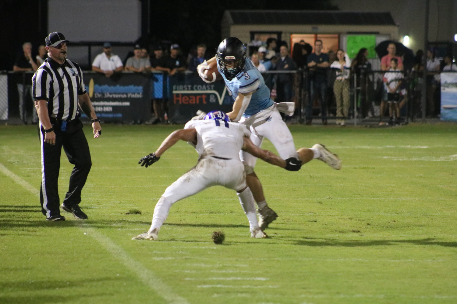 Nate Bunkosky attempts to avoid a Menendez tackler along the sideline.
