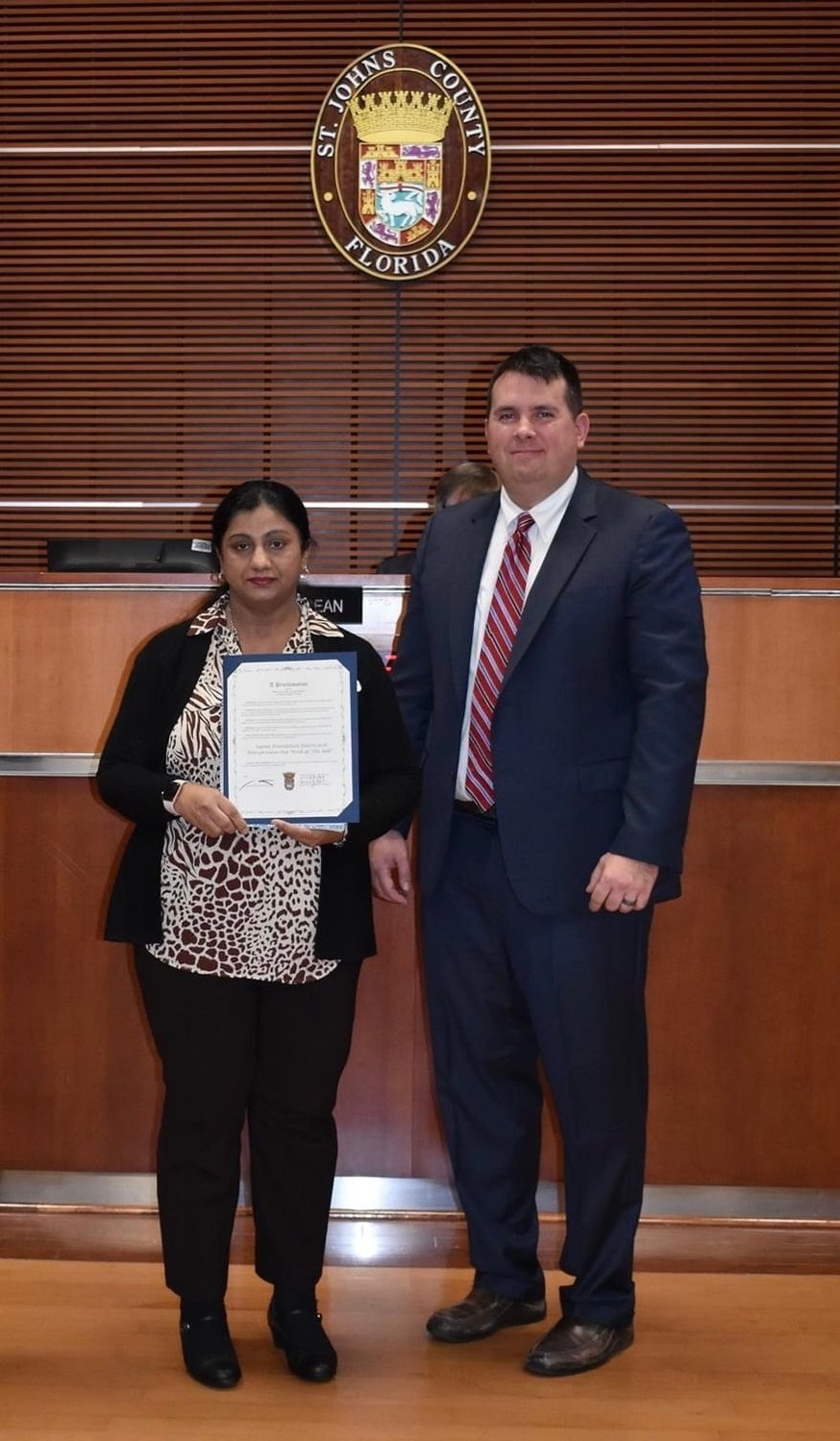 County Commissioner Jeremiah Blocker presents a proclamation to Gurpreet Misra recognizing Entrepreneurial Week.